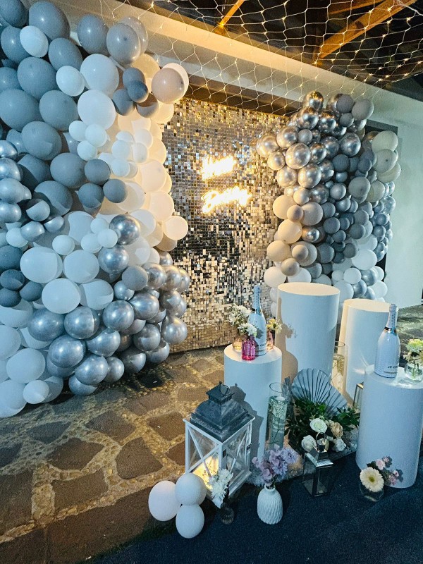 Silver, white and grey balloon event decoration with shimmer wall and styled display